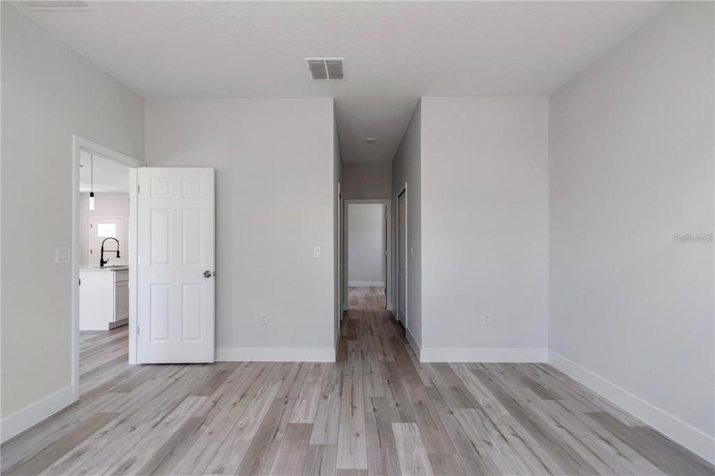 3875 Southwest 169th Ln Road Ocala, FL 34473 - Photo 36 of 46 a view of an empty room with wooden floor