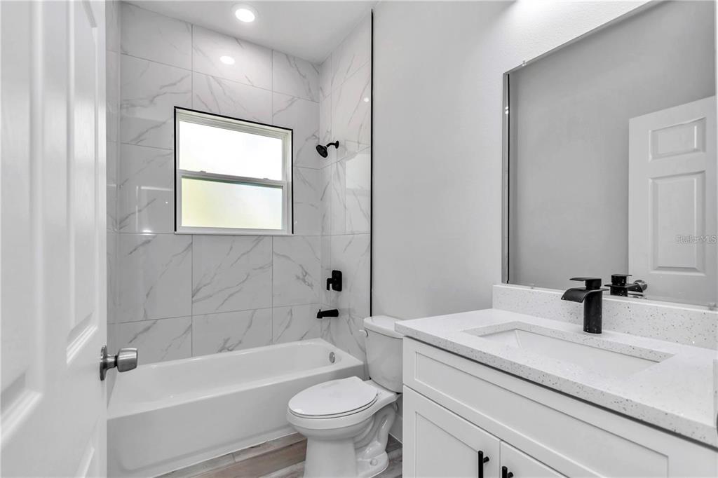 3875 Southwest 169th Ln Road Ocala, FL 34473 - Photo 42 of 46 a bathroom with a sink a toilet and a bathtub