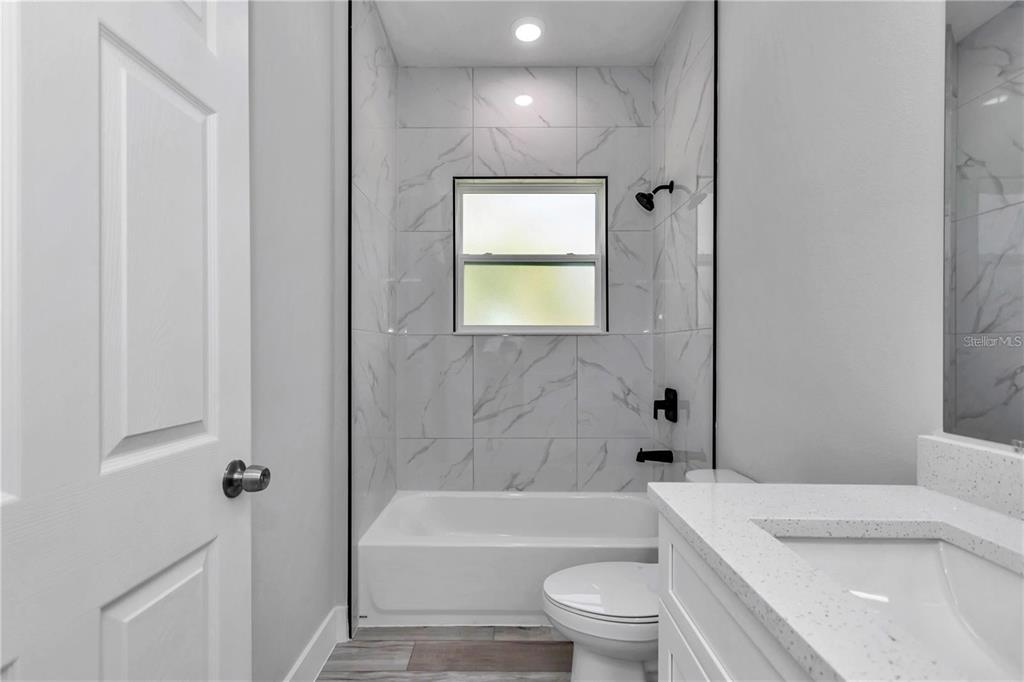 3875 Southwest 169th Ln Road Ocala, FL 34473 - Photo 43 of 46 a bathroom with a toilet a sink and bathtub