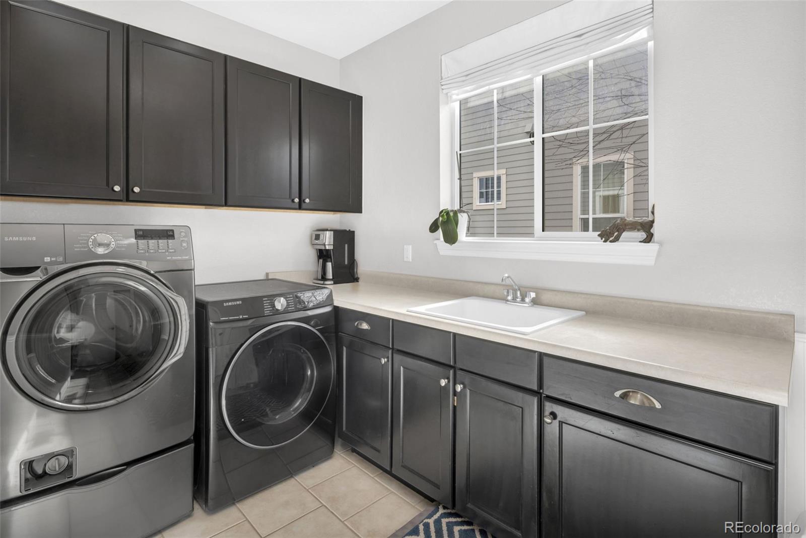 9575 3rd Place Denver, CO 80230 - Photo 15 of 38 a utility room with sink dryer and washer