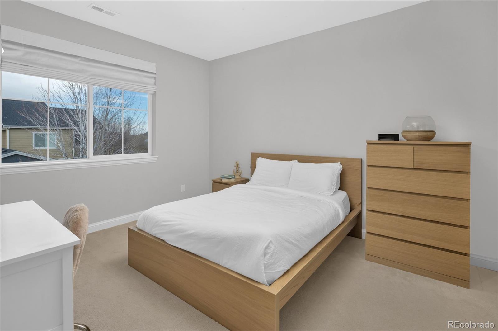 9575 3rd Place Denver, CO 80230 - Photo 23 of 38 a bedroom with a bed and a window