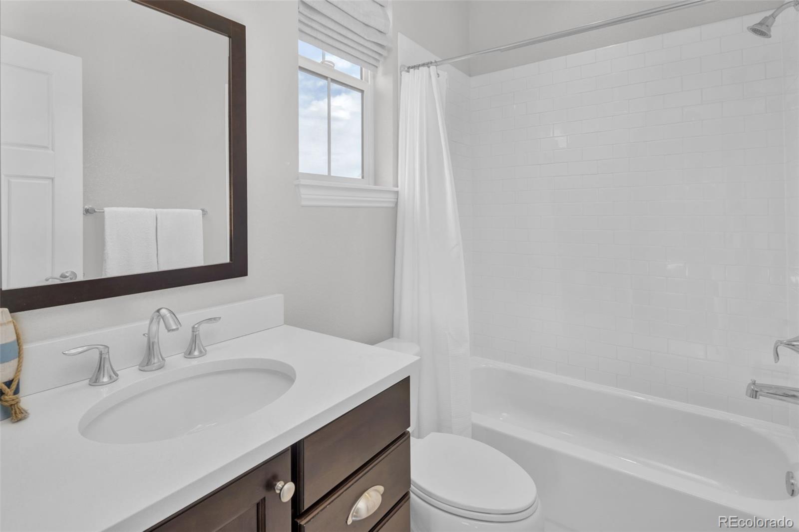 9575 3rd Place Denver, CO 80230 - Photo 24 of 38 a bathroom with a sink toilet vanity and bathtub