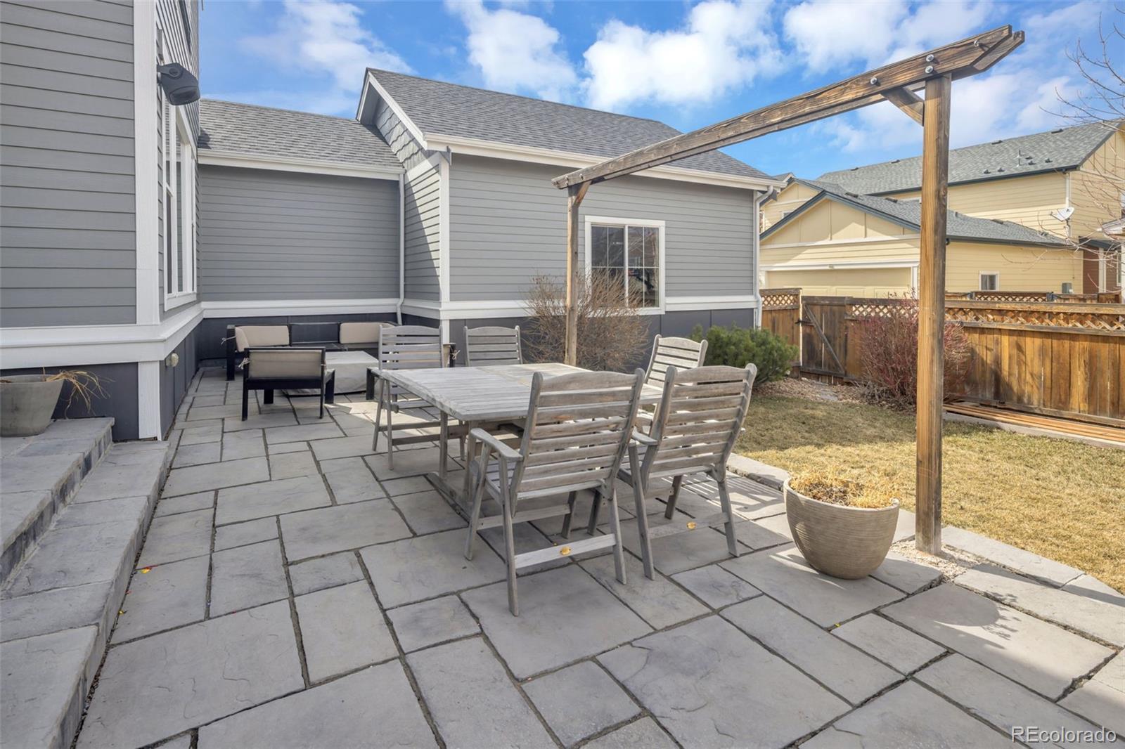 9575 3rd Place Denver, CO 80230 - Photo 34 of 38 a view of a patio with dining table and chairs with wooden floor