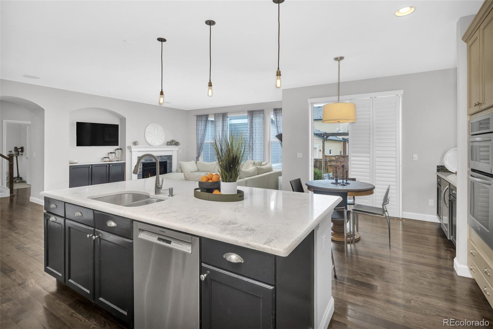 9575 3rd Place Denver, CO 80230 - Photo 7 of 38 a kitchen with a sink a counter and chairs