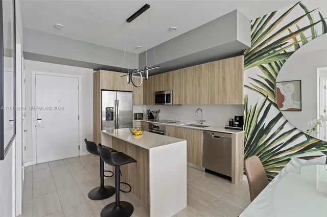 a view of a workspace room with furniture and window