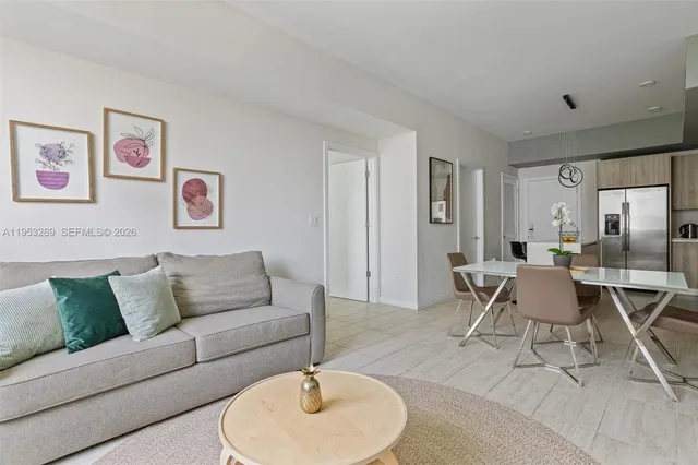 a bedroom with a bed mirror and a window