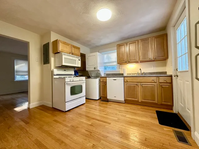 a kitchen with a sink appliances and cabinets