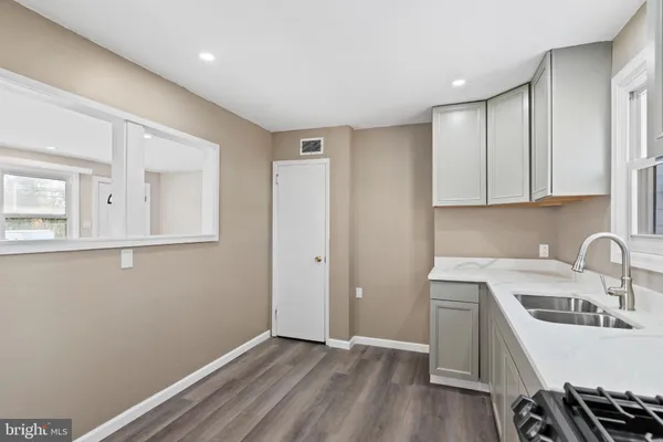 a view of a kitchen with sink and cabinets