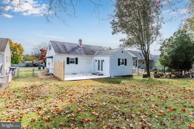 a front view of a house with a garden and yard