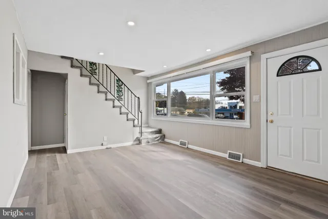 a view of wooden floor and windows in a room