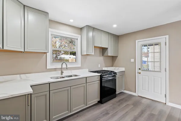 a kitchen with a sink stove and cabinets