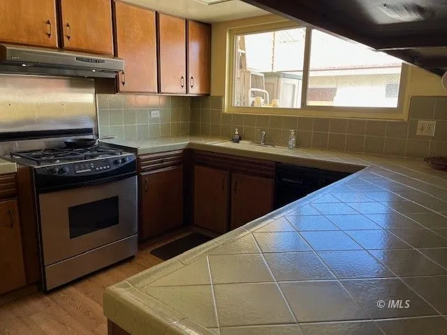 a kitchen with a sink stove and cabinets