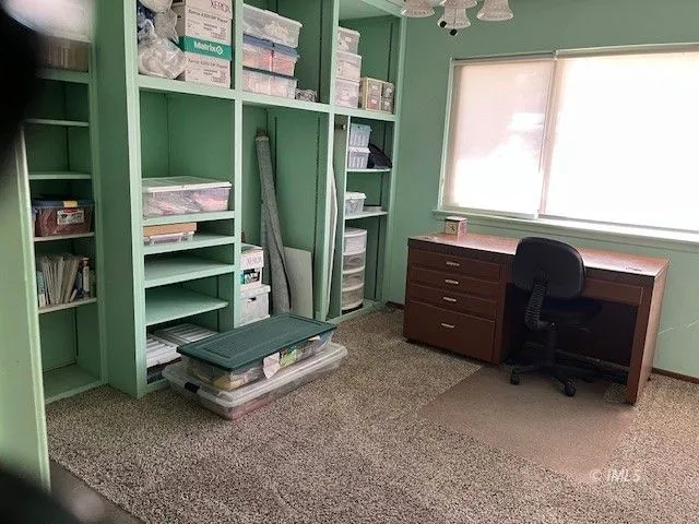 a room with a dresser and a window