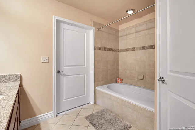 a bathroom with a tub and shower