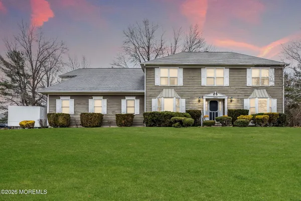 a front view of a building with a yard
