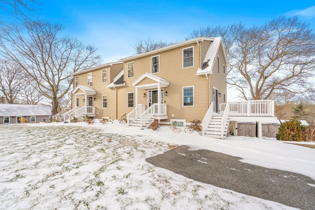 16 Hodgkins Road, Unit 2 Rockport, MA 01966 - Photo 19 of 19 a front view of a house with a dirt yard and a large tree