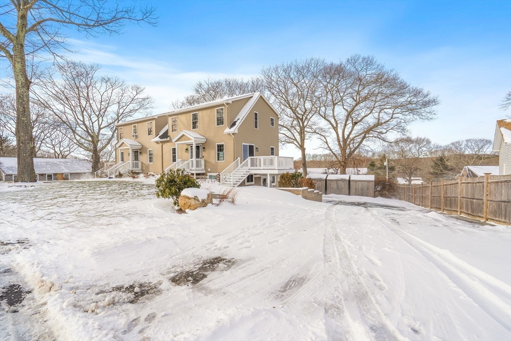 16 Hodgkins Road, Unit 2 Rockport, MA 01966 - Photo 2 of 19 a view of a white house with a yard