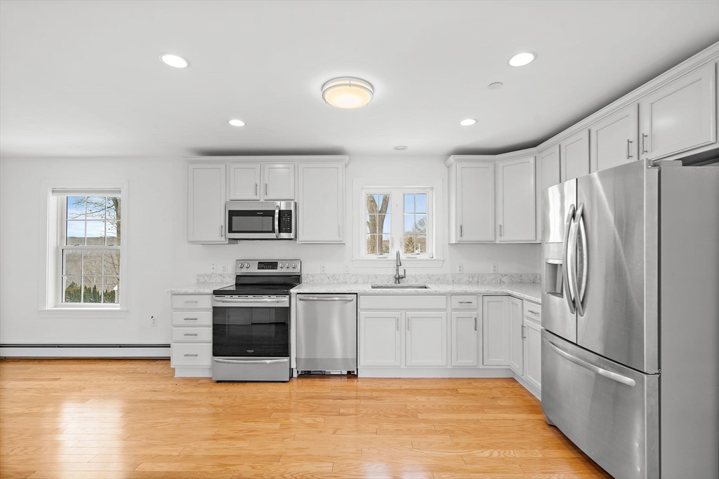 16 Hodgkins Road, Unit 2 Rockport, MA 01966 - Photo 4 of 19 a kitchen with stainless steel appliances granite countertop a refrigerator sink and stove