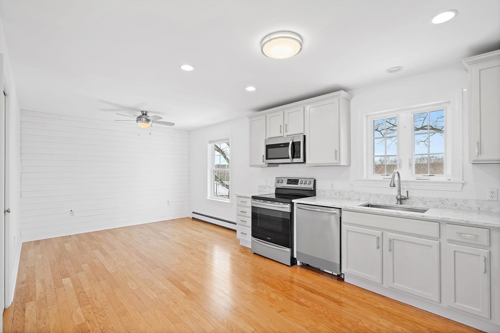 16 Hodgkins Road, Unit 2 Rockport, MA 01966 - Photo 5 of 19 a kitchen with stainless steel appliances granite countertop a sink and stove top oven