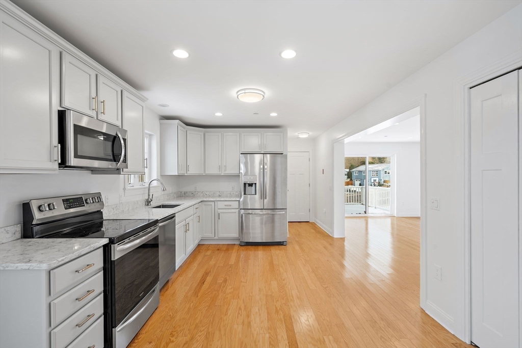 16 Hodgkins Road, Unit 2 Rockport, MA 01966 - Photo 6 of 19 a large kitchen with stainless steel appliances granite countertop a lot of counter space and wooden floor