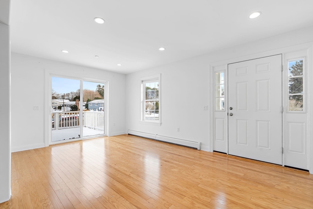 16 Hodgkins Road, Unit 2 Rockport, MA 01966 - Photo 10 of 19 a view of a big room with wooden floor and windows