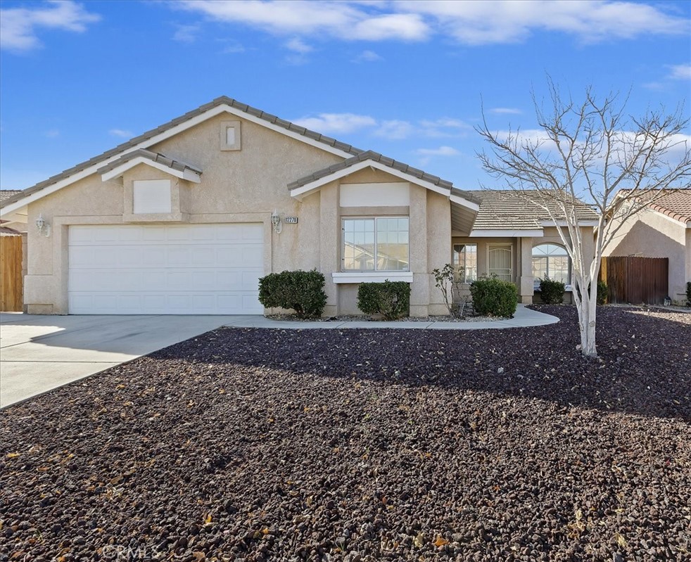 12278 Shadow Drive Victorville, CA 92392 - Photo 1 of 32 a front view of a house with garden