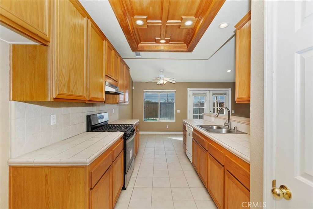 12278 Shadow Drive Victorville, CA 92392 - Photo 13 of 32 a large kitchen with stainless steel appliances granite countertop a sink and cabinets
