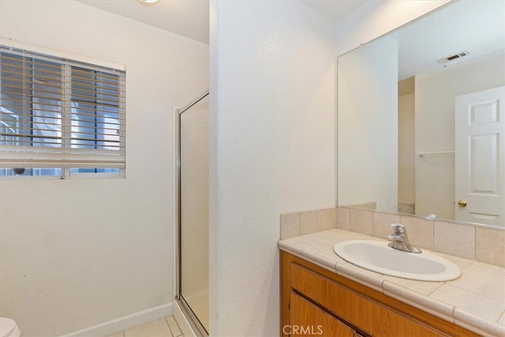 12278 Shadow Drive Victorville, CA 92392 - Photo 16 of 32 a bathroom with a sink and a mirror