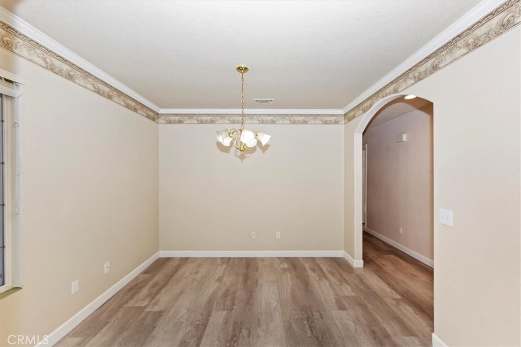 12278 Shadow Drive Victorville, CA 92392 - Photo 6 of 32 a view of a room with wooden floor closet and a window