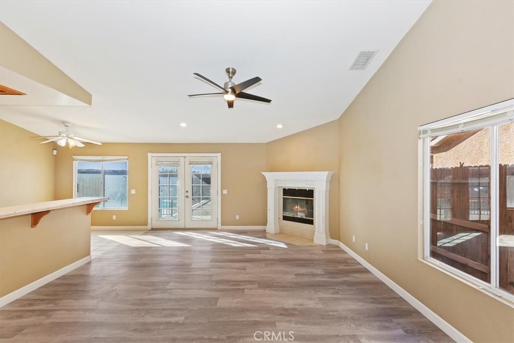 12278 Shadow Drive Victorville, CA 92392 - Photo 7 of 32 a view of an empty room with a window and wooden floor