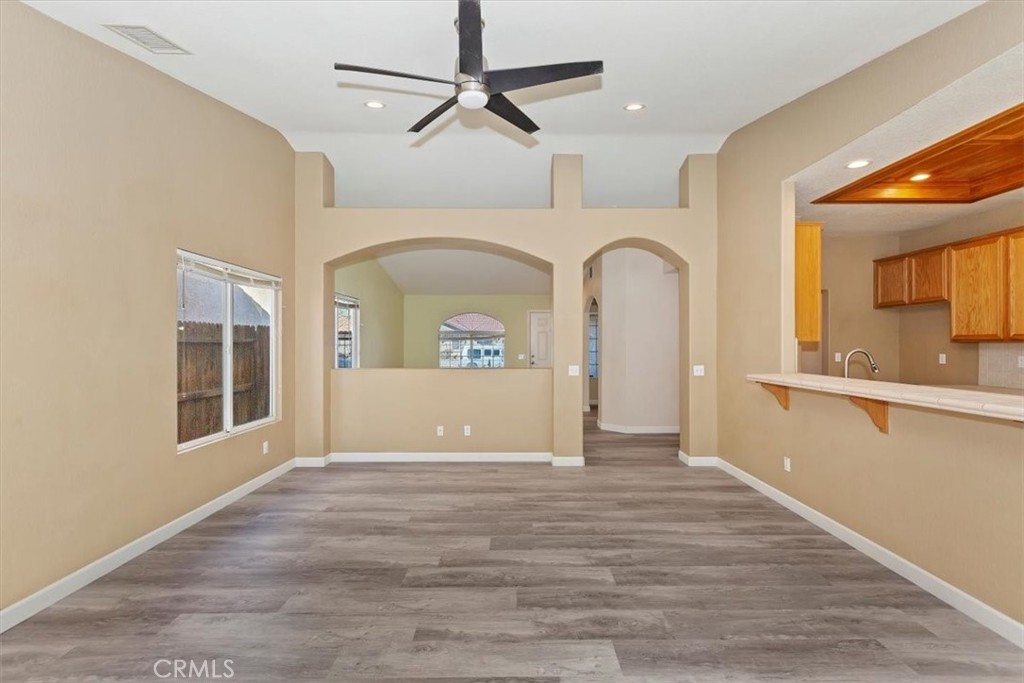 12278 Shadow Drive Victorville, CA 92392 - Photo 9 of 32 a view of a livingroom with wooden floor and a ceiling fan