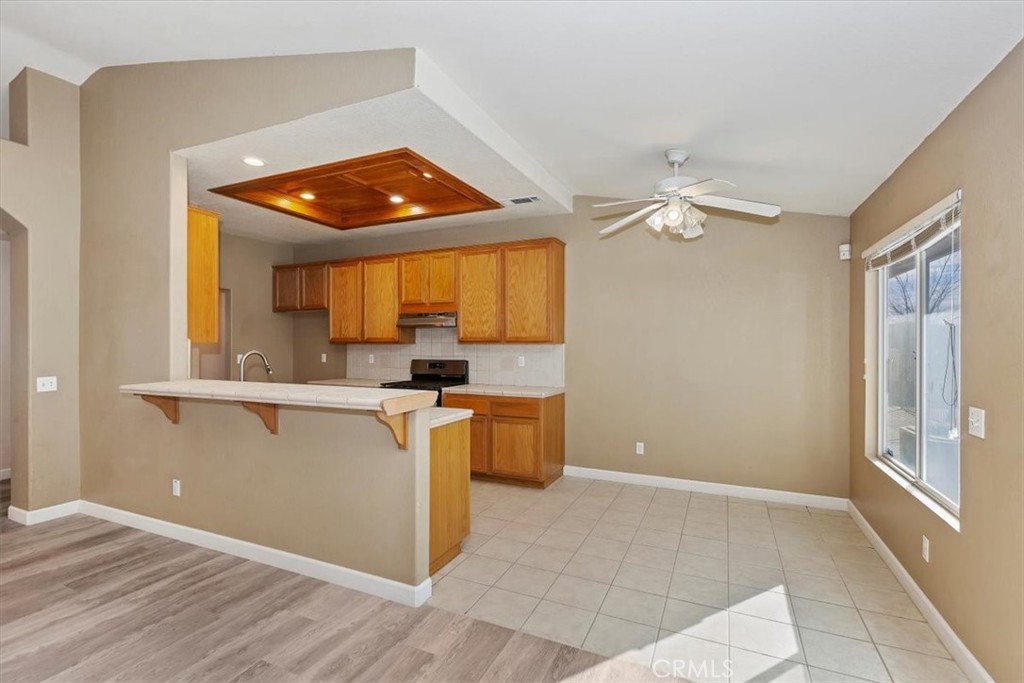 12278 Shadow Drive Victorville, CA 92392 - Photo 10 of 32 a view of kitchen with stainless steel appliances granite countertop cabinets and window