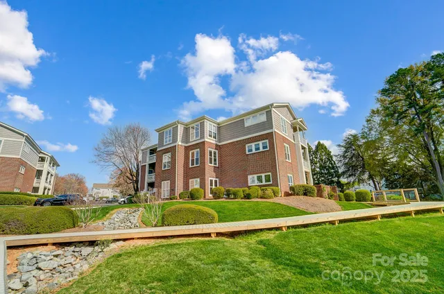 a view of a big building with a big yard and plants