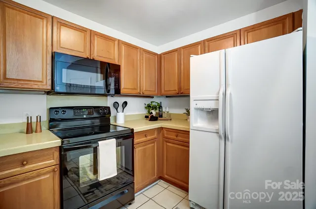 a bathroom with a granite countertop double vanity sink a mirror and toilet