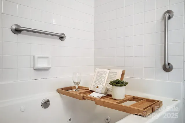 a spacious bedroom with a bed and a chandelier