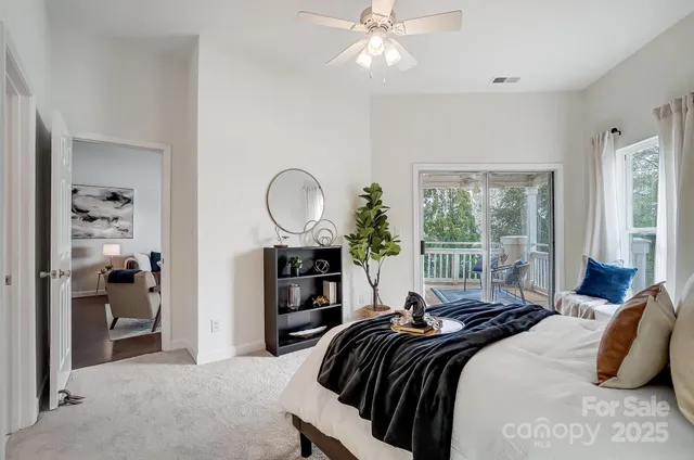 a living room with furniture and a floor to ceiling window