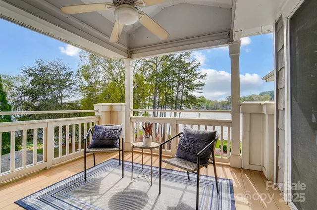 a roof deck with table and chairs and wooden floor