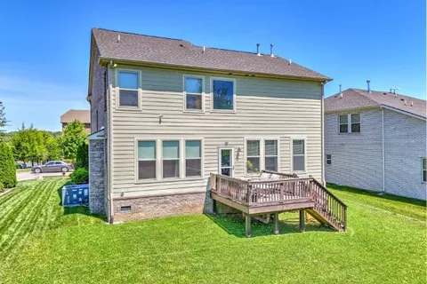 a view of a grassy field with trees