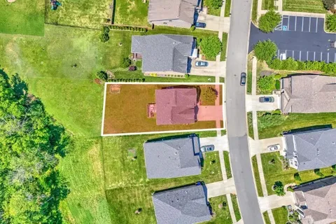 an aerial view of a house with a swimming pool