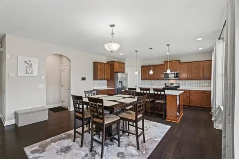 a view of a dining room with furniture and wooden floor
