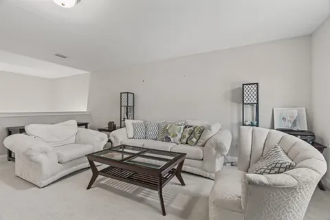 a living room with furniture a rug and a couch