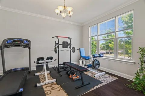 a living room with furniture a dining table and a window