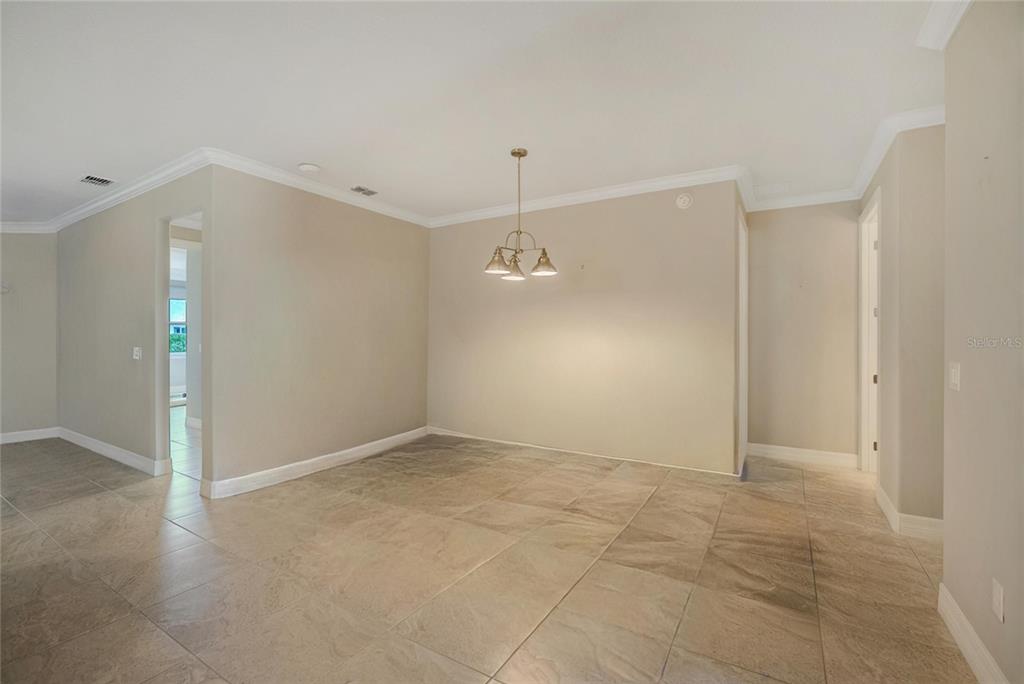 9550 Southwest 64th Lane Ocala, FL 34481 - Photo 12 of 58 an empty room with fan and entrance