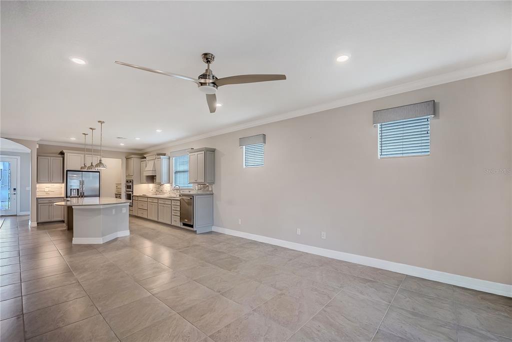 9550 Southwest 64th Lane Ocala, FL 34481 - Photo 16 of 58 a kitchen with a refrigerator and white cabinets