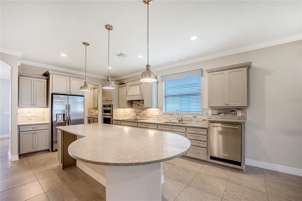 9550 Southwest 64th Lane Ocala, FL 34481 - Photo 19 of 58 a kitchen with stainless steel appliances granite countertop a sink stove and refrigerator