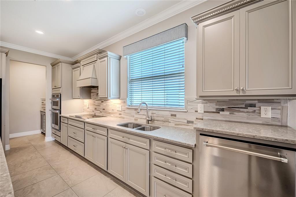 9550 Southwest 64th Lane Ocala, FL 34481 - Photo 20 of 58 a kitchen with stainless steel appliances granite countertop a sink and a stove