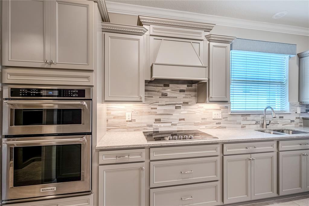 9550 Southwest 64th Lane Ocala, FL 34481 - Photo 21 of 58 a kitchen with granite countertop white cabinets stainless steel appliances and sink