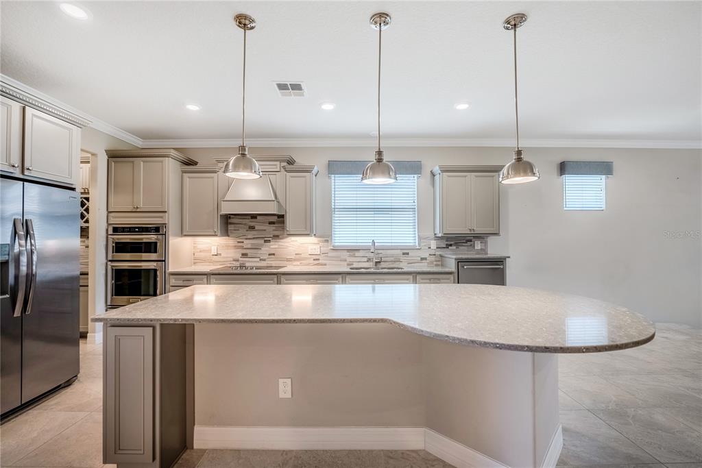 9550 Southwest 64th Lane Ocala, FL 34481 - Photo 22 of 58 a kitchen with kitchen island a counter top stainless steel appliances and cabinets