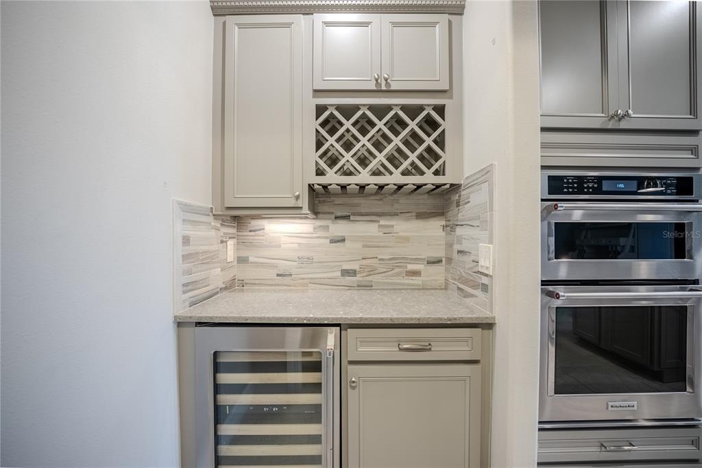 9550 Southwest 64th Lane Ocala, FL 34481 - Photo 23 of 58 a kitchen with granite countertop white cabinets and stainless steel appliances