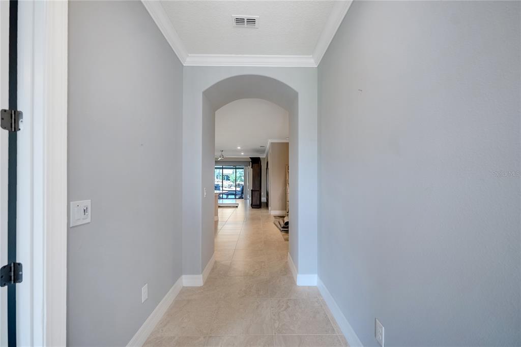 9550 Southwest 64th Lane Ocala, FL 34481 - Photo 3 of 58 a view of a hallway with wooden floor and a bathroom